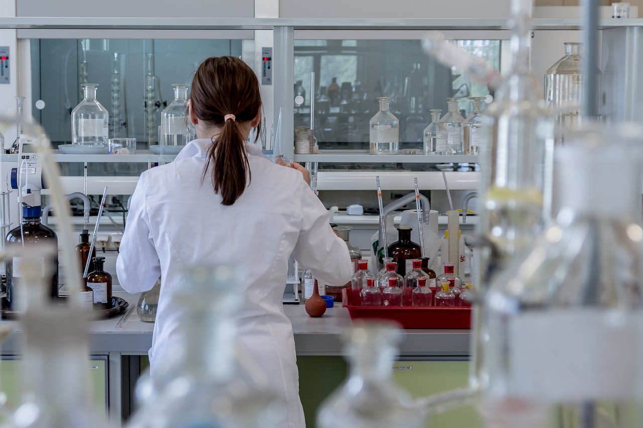 female technician in lab seen from behind