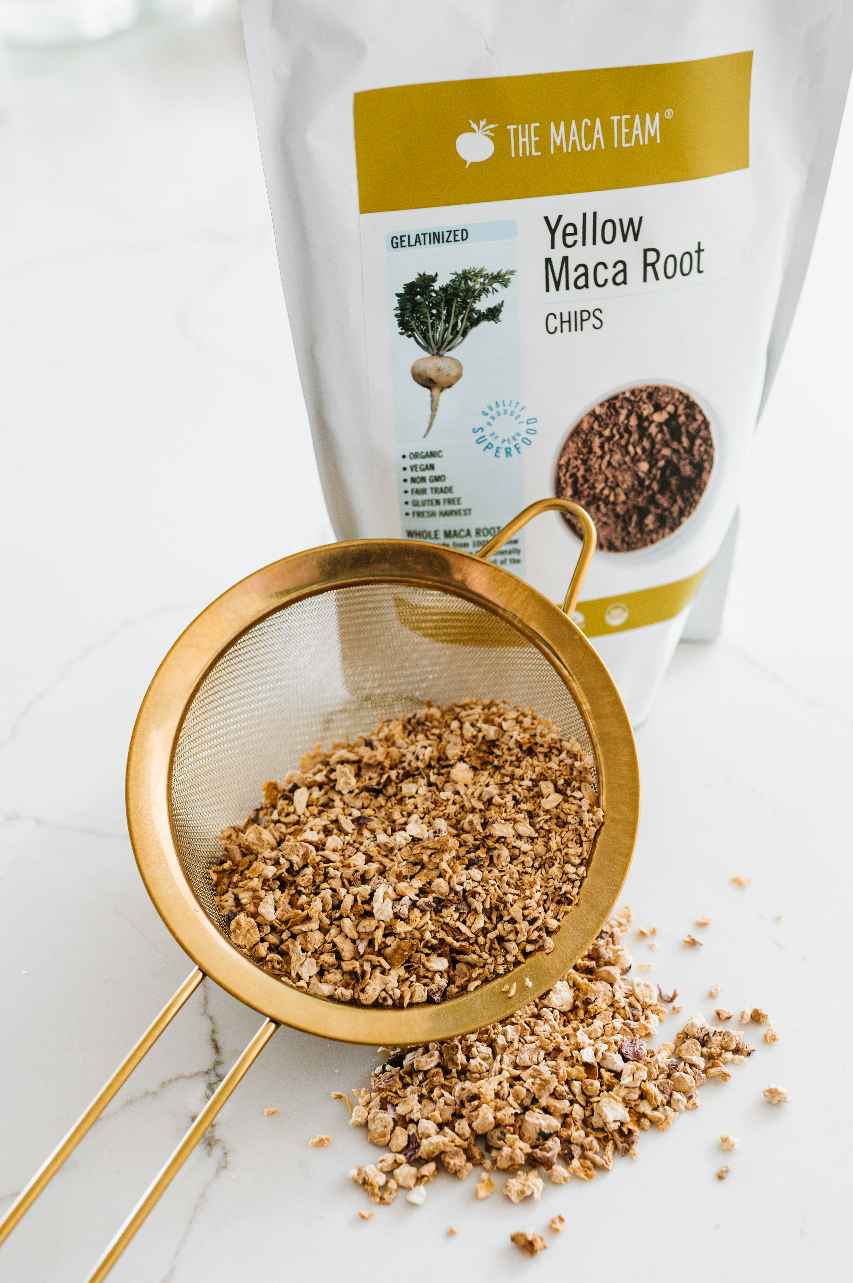 gelatinized yellow whole maca chips bag and chips in a sieve