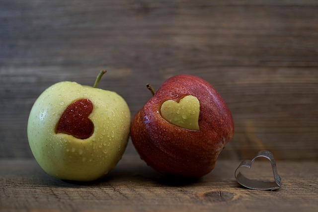 green and red apples with heart cutouts