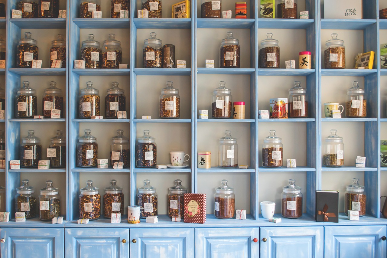 wall with glass jars of herbal medicines on shelves - shop themacateam.com
