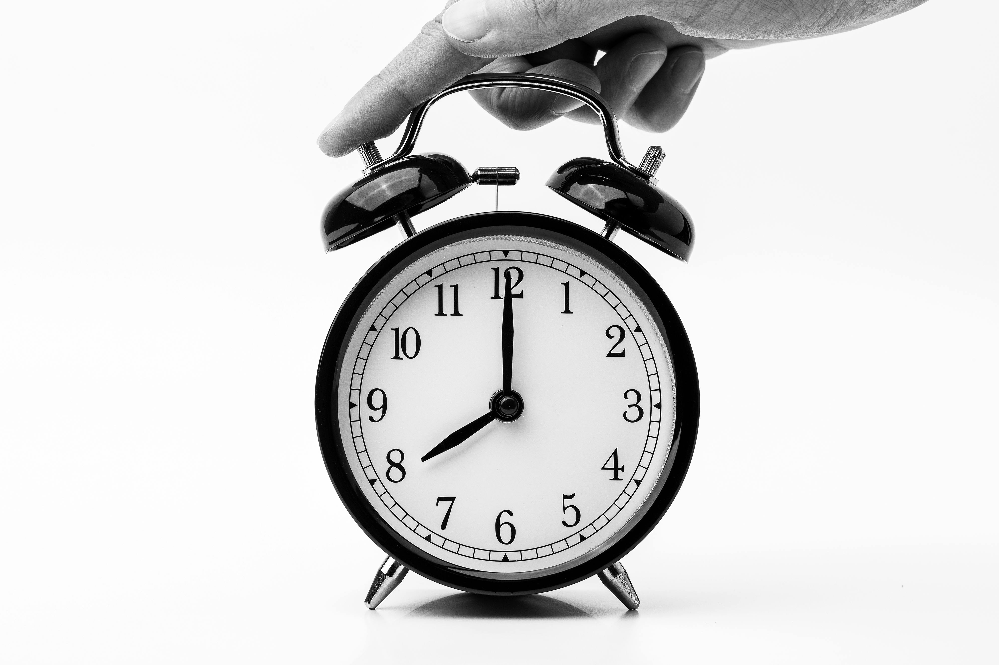 Old-fashioned clock with someone's hand turning it off - Shop TheMacaTeam.com. 