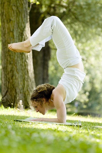 woman in upside down yoga pose outdoors