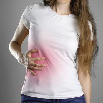 Maca and Liver Health Person placing a hand over the upper abdomen in an article about maca and liver health