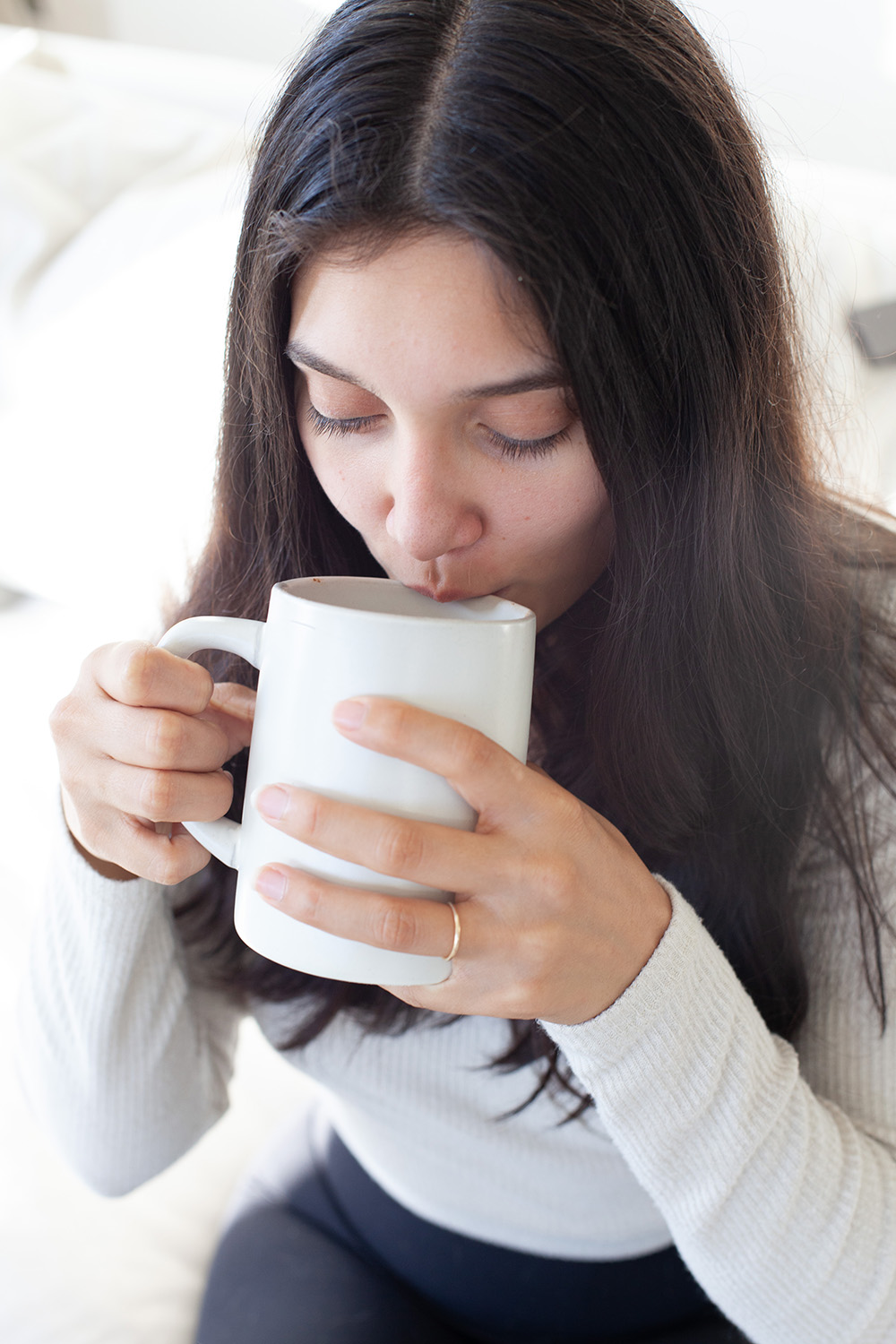 A quiet morning ritual with a warm mug on the sofa