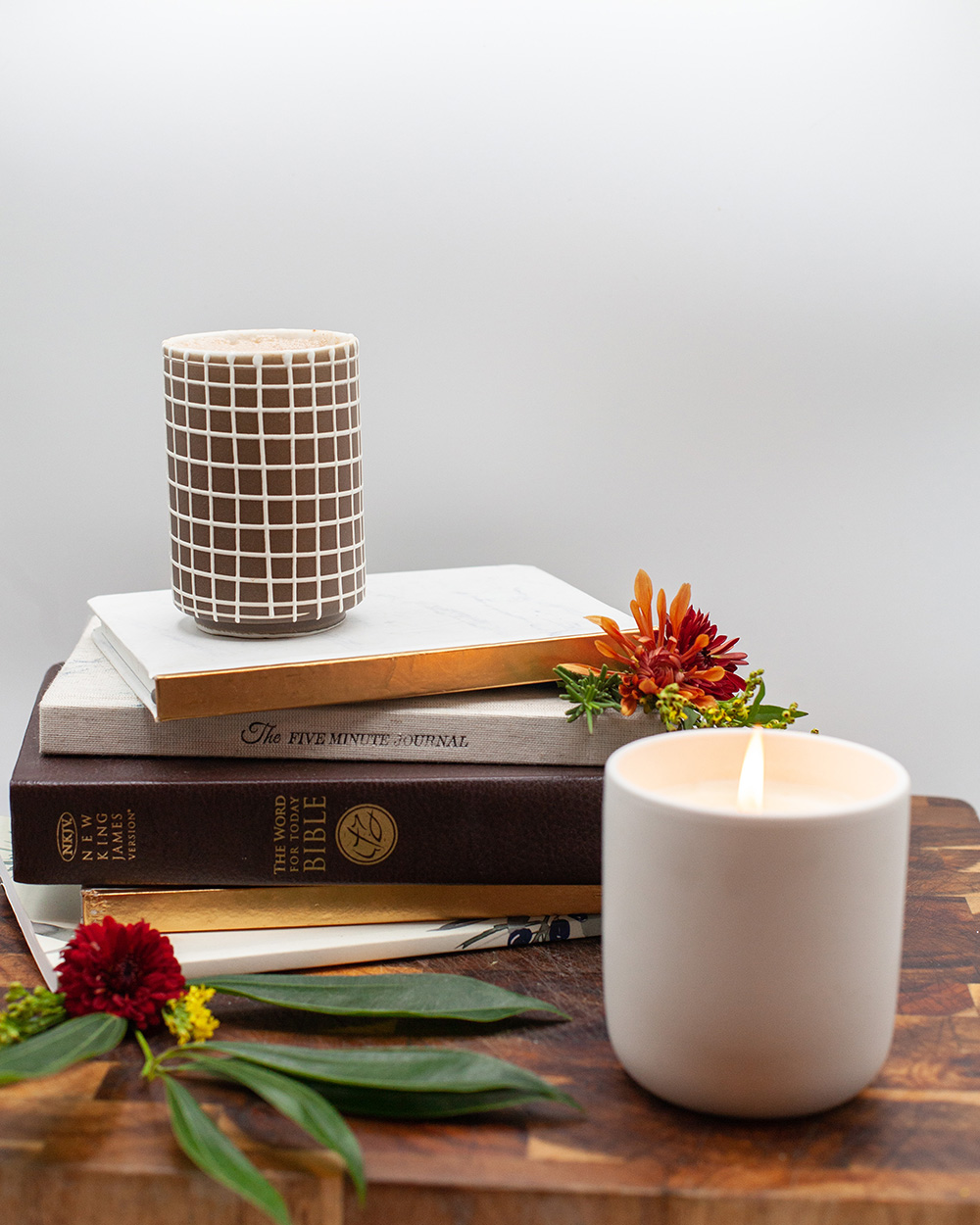 A warm Morning Motivator drink served beside books and flowers